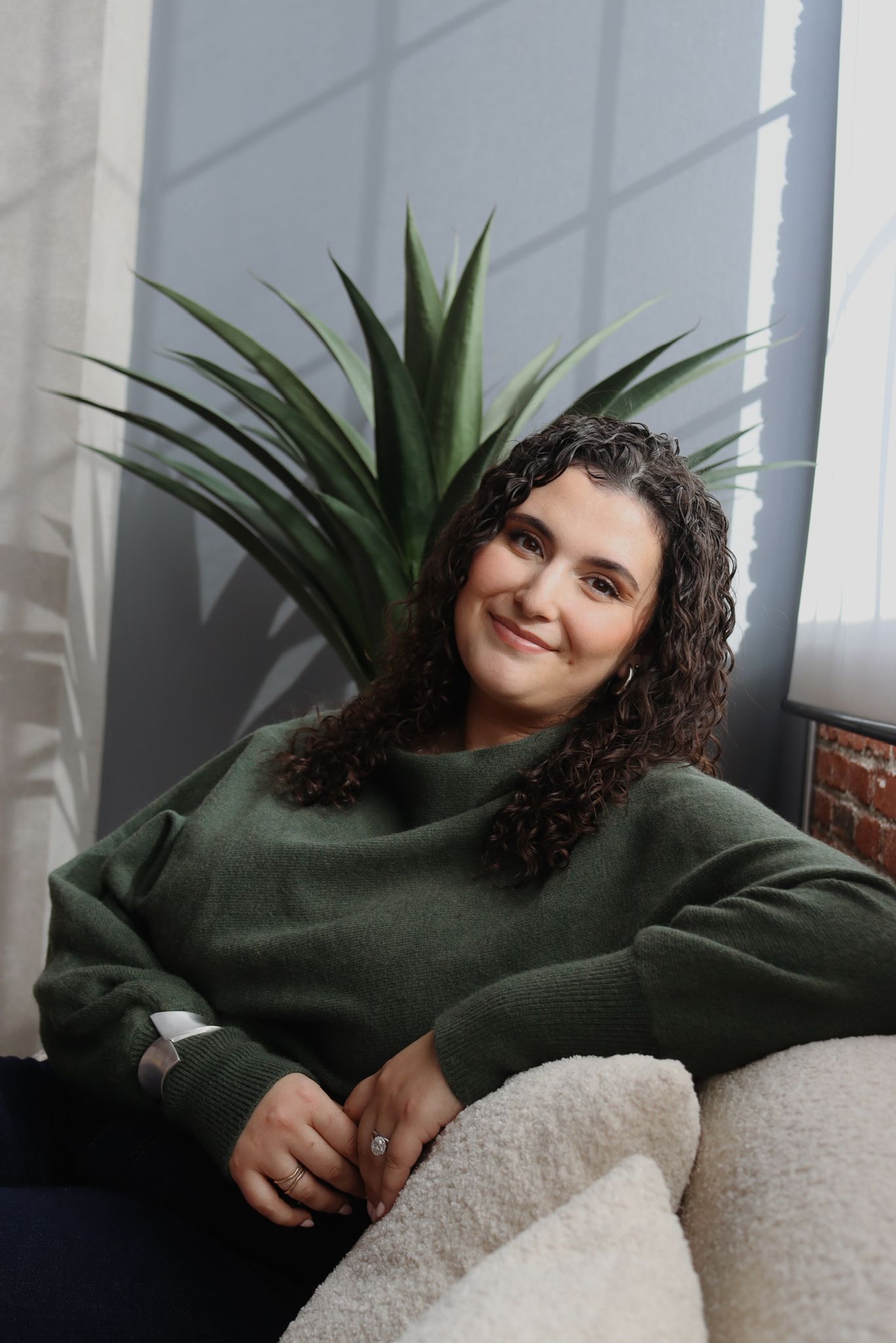Shir Elmaleh with plant, smiling
