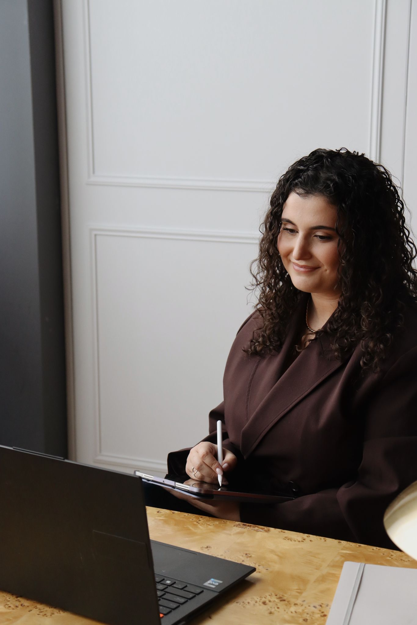 Working at laptop, smiling